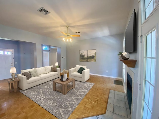 living room featuring ceiling fan and light parquet flooring