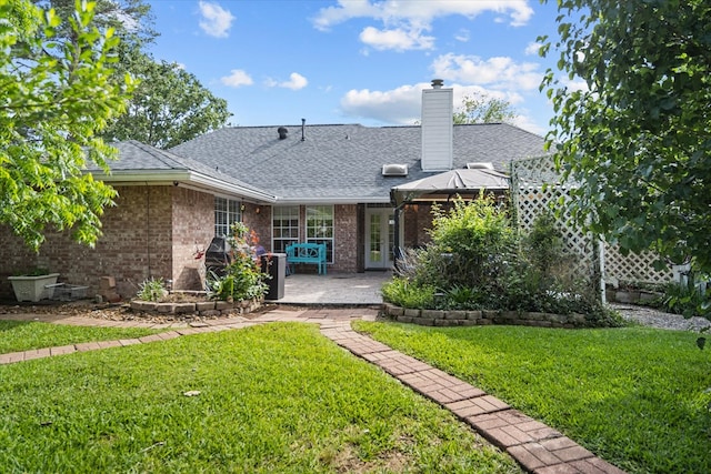 rear view of property with a gazebo, a yard, and a patio area