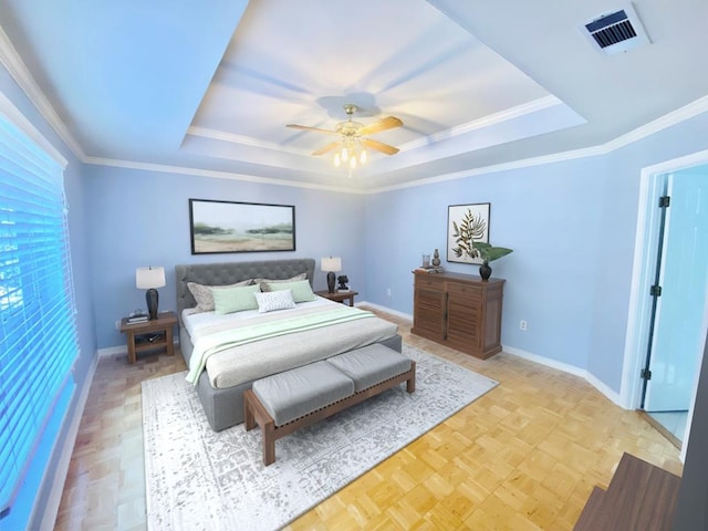 bedroom with ceiling fan, crown molding, a tray ceiling, and light parquet flooring