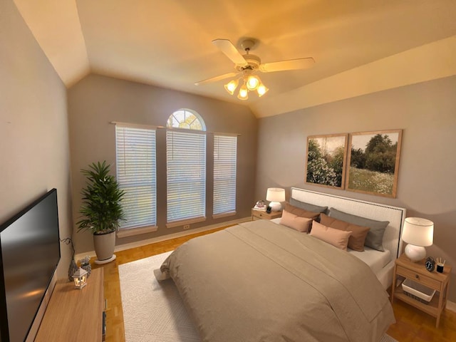 bedroom featuring ceiling fan, hardwood / wood-style floors, and vaulted ceiling