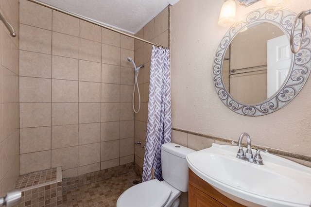 bathroom featuring a shower with curtain, vanity, a textured ceiling, and toilet