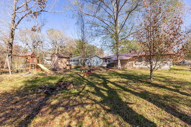 view of yard featuring a playground and a shed