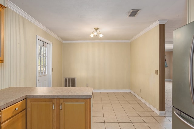 kitchen featuring kitchen peninsula, stainless steel fridge, ornamental molding, light tile patterned floors, and a notable chandelier