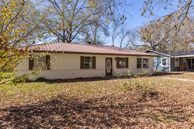 1407 Fairchild Dr, Diboll, TX 75941 - ranch-style home featuring a metal roof and brick siding