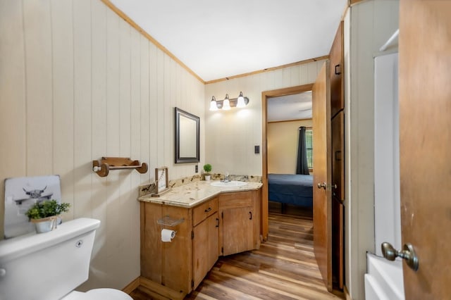 914 County Road 849, Cushing, TX 75760 - kitchen featuring stainless steel appliances, under cabinet range hood, brown cabinets, wood walls, and light tile patterned floors