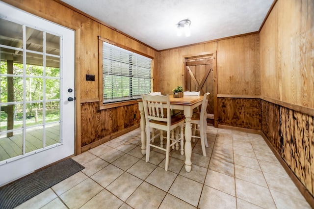 914 County Road 849, Cushing, TX 75760 - kitchen with a wood stove, appliances with stainless steel finishes, light tile patterned flooring, dark countertops, and wooden walls