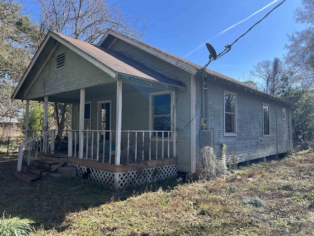 view of side of home featuring a porch