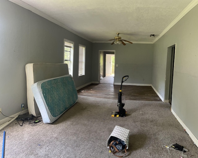 interior space with a textured ceiling, hardwood / wood-style flooring, ceiling fan, and ornamental molding