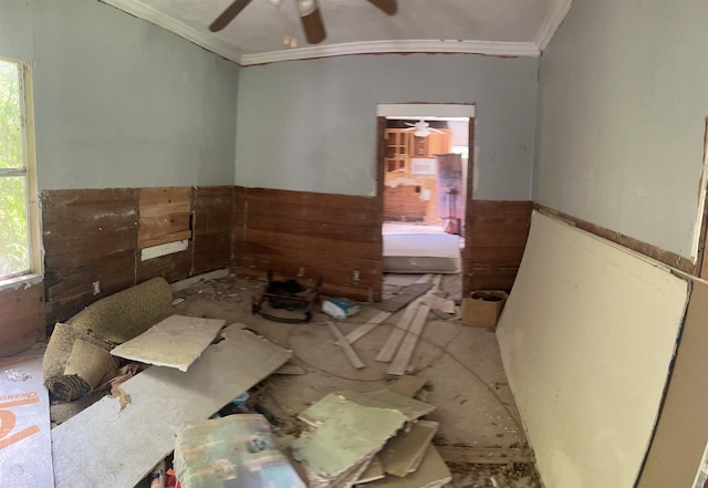 misc room with wood walls and ornamental molding