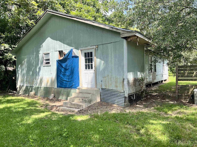 view of outbuilding with a lawn