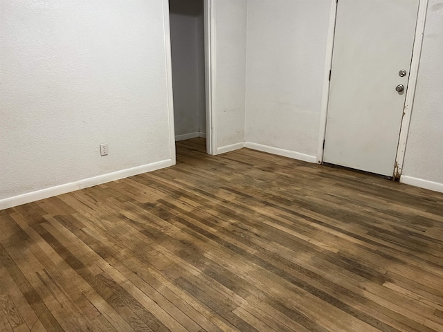 empty room with dark hardwood / wood-style floors