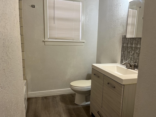 bathroom featuring wood-type flooring, vanity, and toilet