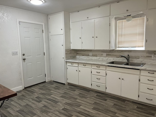 kitchen with white cabinetry, sink, dark hardwood / wood-style floors, a textured ceiling, and decorative backsplash