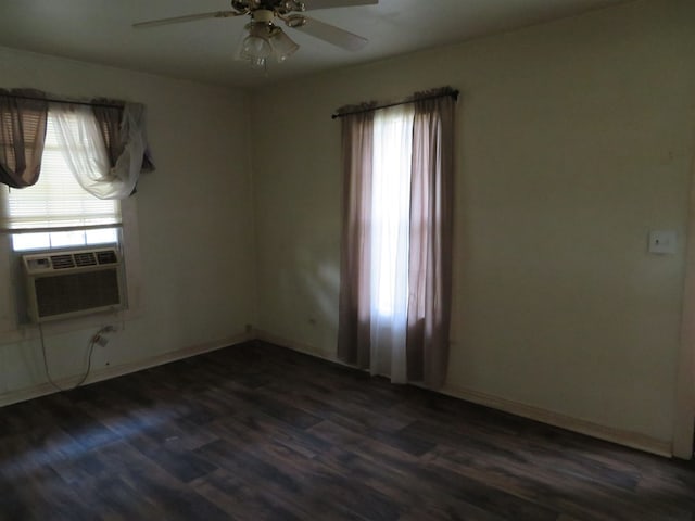 spare room featuring dark hardwood / wood-style flooring, ceiling fan, and a healthy amount of sunlight