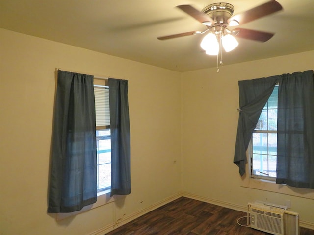 spare room featuring a wall mounted air conditioner and dark hardwood / wood-style floors