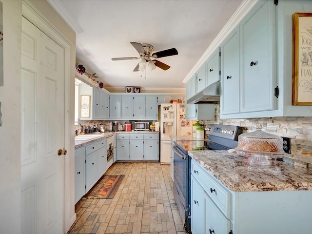 1145 State Highway 21e, San Augustine, TX 75972 - kitchen featuring decorative backsplash, a ceiling fan, under cabinet range hood, and appliances with stainless steel finishes