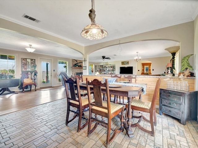 1145 State Highway 21e, San Augustine, TX 75972 - dining area featuring arched walkways, visible vents, crown molding, and ceiling fan