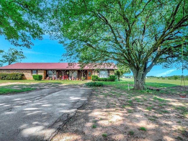 1145 State Highway 21e, San Augustine, TX 75972 - ranch-style house with metal roof and aphalt driveway