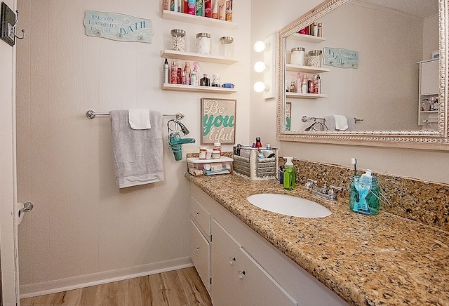 bathroom with hardwood / wood-style floors and vanity