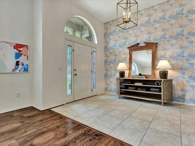 301 Sawgrass Cir, Lufkin, TX 75901 - foyer entrance with healthy amount of natural light, wallpapered walls, a chandelier, wood finished floors, and a high ceiling