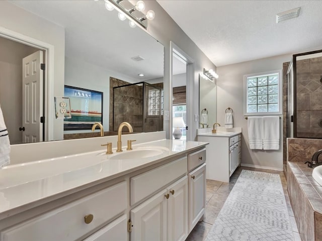 301 Sawgrass Cir, Lufkin, TX 75901 - full bathroom with two vanities, a shower stall, and a garden tub