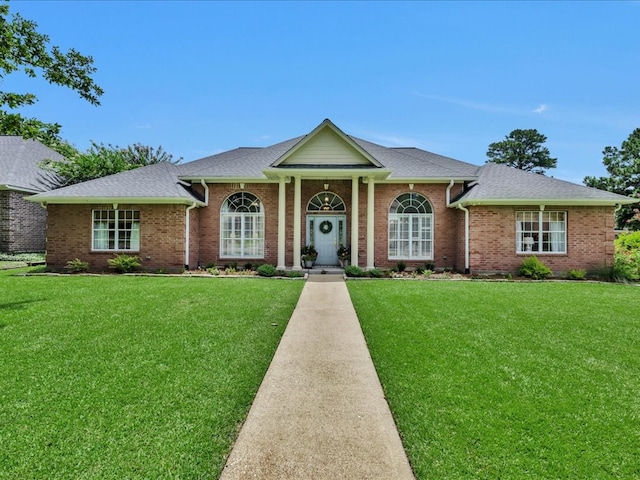 301 Sawgrass Cir, Lufkin, TX 75901 - neoclassical / greek revival house with a front yard, brick siding, and roof with shingles