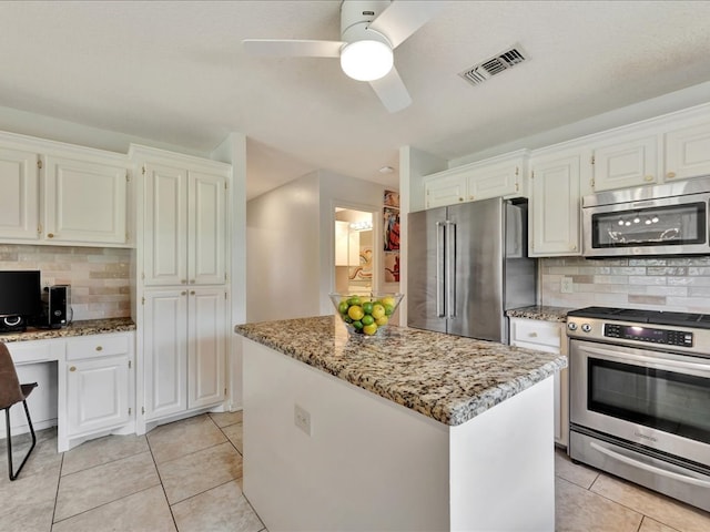 301 Sawgrass Cir, Lufkin, TX 75901 - kitchen featuring stainless steel appliances, light tile patterned flooring, light stone counters, backsplash, and ceiling fan