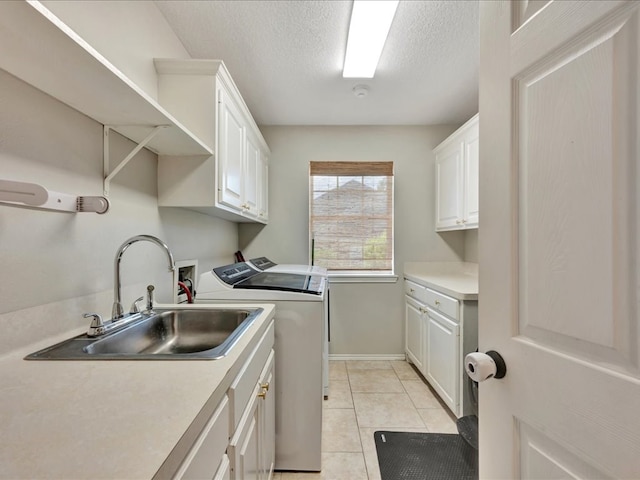 301 Sawgrass Cir, Lufkin, TX 75901 - laundry room featuring cabinet space, washer and dryer, light tile patterned floors, and a textured ceiling