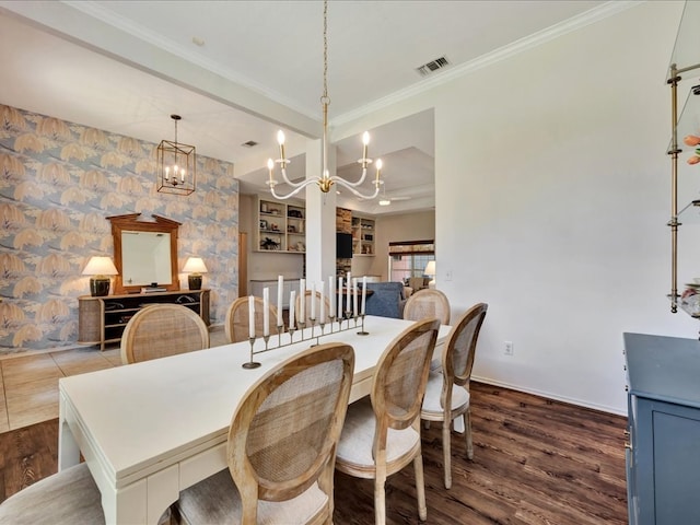 301 Sawgrass Cir, Lufkin, TX 75901 - dining space with wood finished floors, crown molding, built in features, and a chandelier