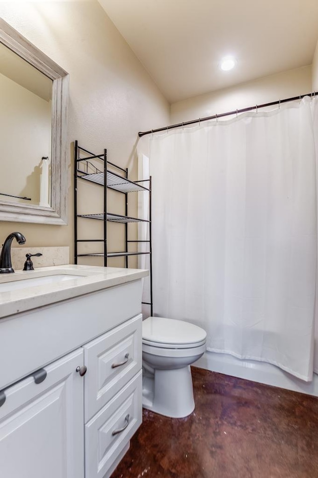 bathroom with vanity, concrete flooring, and toilet