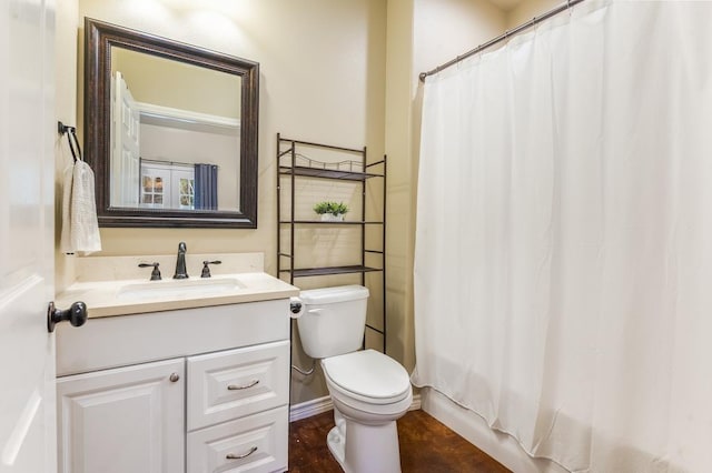 bathroom with vanity, curtained shower, and toilet