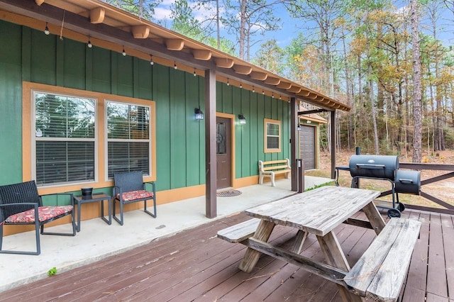 wooden deck featuring a grill