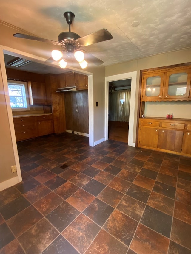 kitchen featuring ceiling fan and a textured ceiling