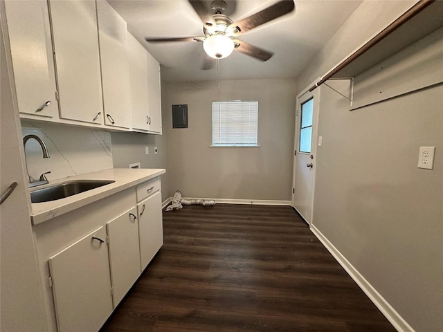 laundry area with sink, dark wood-type flooring, ceiling fan, cabinets, and hookup for an electric dryer