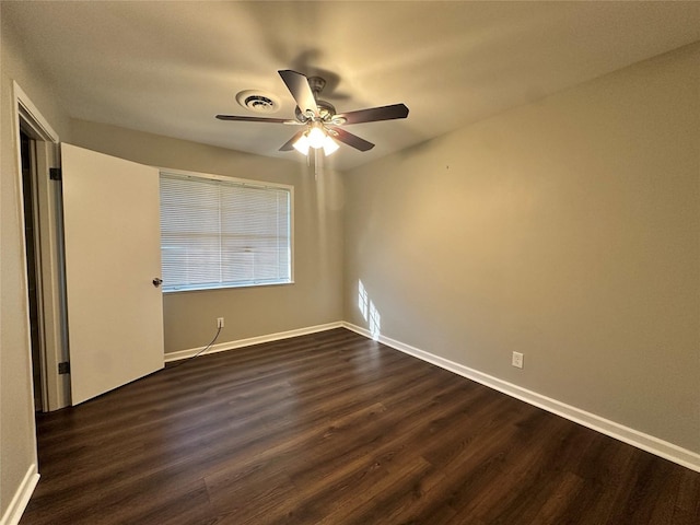 spare room featuring ceiling fan and dark hardwood / wood-style floors