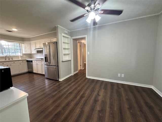 kitchen with crown molding, dark wood-type flooring, ceiling fan, white cabinetry, and stainless steel appliances