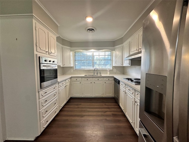 kitchen featuring dark hardwood / wood-style flooring, sink, white cabinets, and appliances with stainless steel finishes