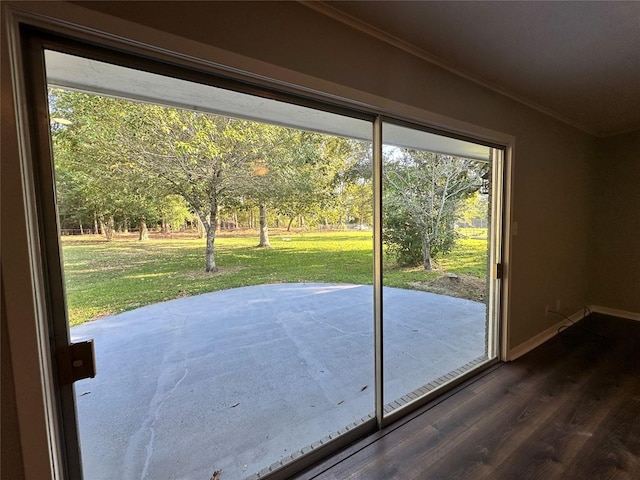 doorway to outside featuring a wealth of natural light, ornamental molding, and dark hardwood / wood-style floors