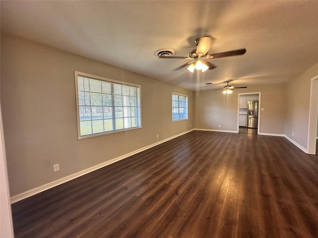 spare room featuring ceiling fan and dark hardwood / wood-style flooring