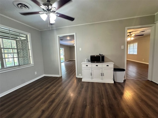 interior space featuring dark hardwood / wood-style flooring, ornamental molding, and ceiling fan