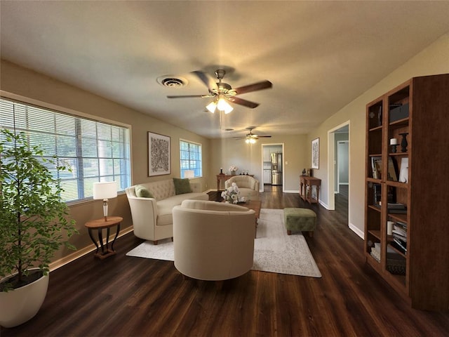 living room with ceiling fan and dark hardwood / wood-style flooring