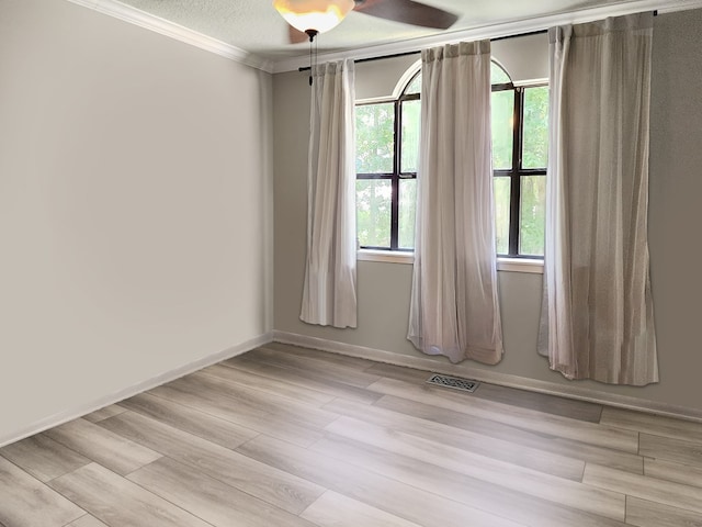 203 Bogey Ln, Brookeland, TX 75931 - unfurnished room with crown molding, light wood-style floors, and a ceiling fan