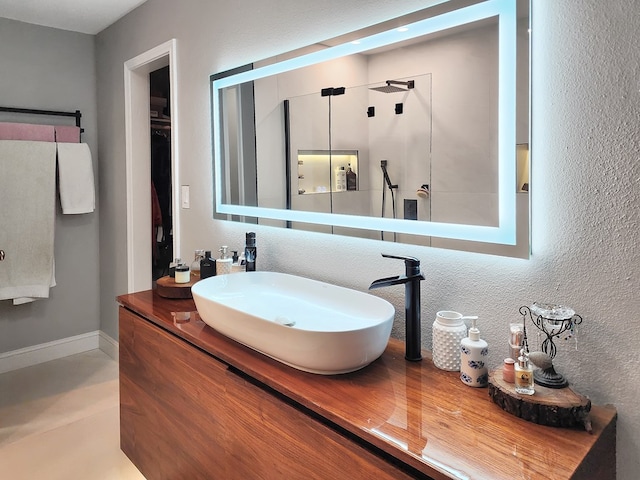 203 Bogey Ln, Brookeland, TX 75931 - full bathroom with double vanity and a textured wall