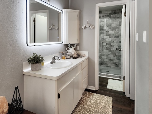203 Bogey Ln, Brookeland, TX 75931 - bathroom with a shower stall, vanity, and wood finished floors