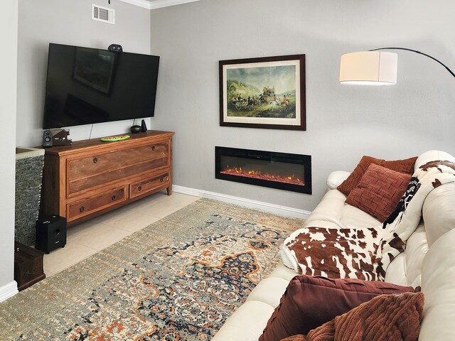 203 Bogey Ln, Brookeland, TX 75931 - tiled living area with a glass covered fireplace and crown molding
