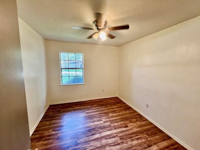 empty room featuring ceiling fan and dark wood-type flooring