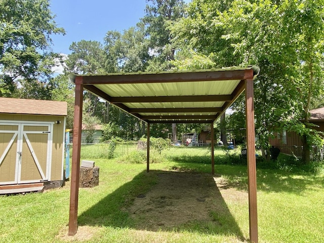 view of yard with a carport and a storage shed