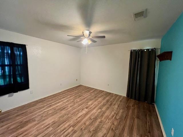 empty room with ceiling fan and hardwood / wood-style flooring