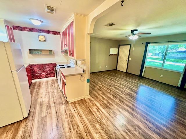 kitchen featuring ceiling fan, light hardwood / wood-style floors, and white appliances