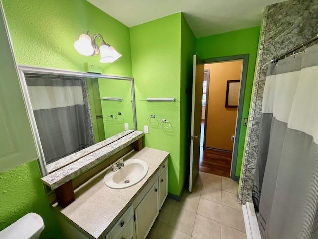 bathroom with tile patterned floors, vanity, and walk in shower